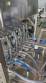 Complete filling line with Tecman Nelpas Tecnoenvase Tudela bottle filling, labeling, capping, and positioning machines for cosmetic liquids.