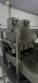 Automatic stainless steel deep fryer for donuts and cream puffs.