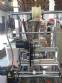 Vertical wrapping machine for triangular format