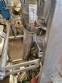 Vertical wrapping machine for triangular format