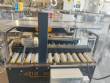 Adhesive tape case sealer with safety enclosure and door sensors Strapack