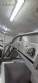 Inova Industrial inclined stainless steel conveyor belt with cleats.