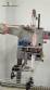 Label applicator machine with steam-operated shrink tunnel for sleeves.