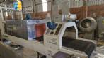 Labeling machine with steam sleeve tunnel and bottle baler