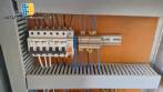 Labeling machine with steam sleeve tunnel and bottle baler