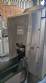 Labeling machine with steam sleeve tunnel and bottle baler