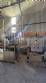 Labeling machine with steam sleeve tunnel and bottle baler
