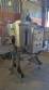Labeling machine with steam sleeve tunnel and bottle baler