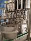Zegla rotary filling machine with rinser and three-block capping system.