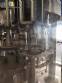 Zegla rotary filling machine with rinser and three-block capping system.