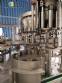 Zegla rotary filling machine with rinser and three-block capping system.